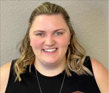 FEMALE EMPLOYEE IN FRONT OF GRAY Background